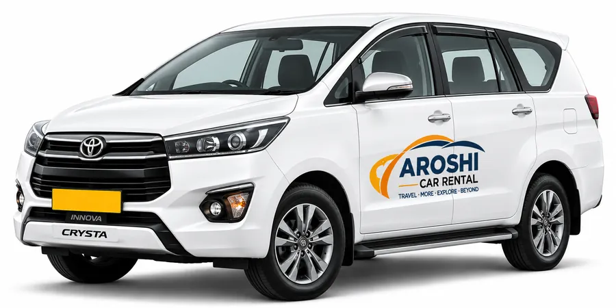 White Toyota Innova Crysta with Aroshi Car Rental branding
